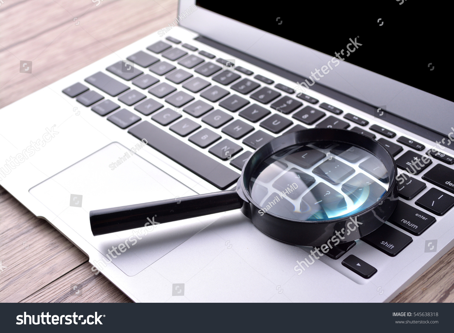 Image of a laptop computer with a magnifying glass hovering over the Enfissi.com website address in the browser, emphasizing the scrutiny and investigation of the site's legitimacy.